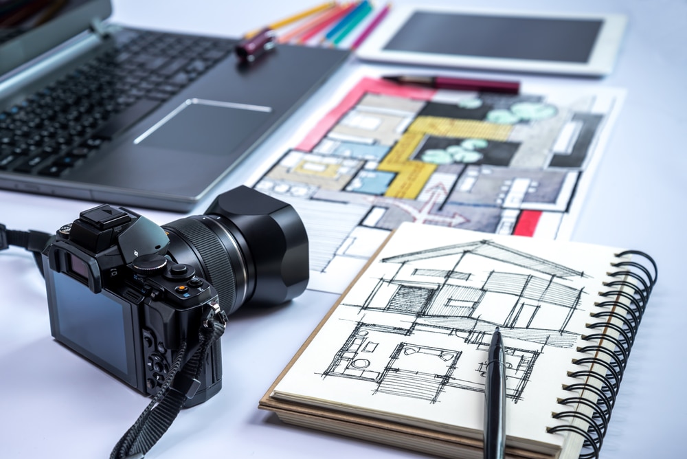 Closeup Of Camera, Laptop, Tablet, Home Illustration & Equipments On Desk